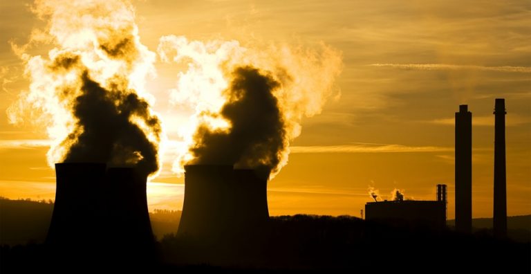Smoke pours from chimney stacks at coal-fired power station (emissions trading)