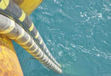 AER delivers final revenue decision for regulated Basslink Subsea cable being lowered into blue-green ocean waters (suncable tasmania)