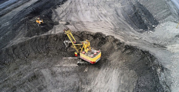 coal mine with large yellow digger