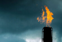 Queensland launches gas-fired generation capacity tender Gas flame from industrial chimney against cloudy sky (gas deals)