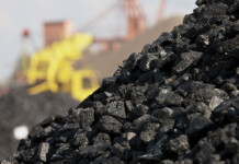 Giant coal mine approved despite ‘inadequate’ climate plan Close up of coal mound with industrial machinery in background (coal super fund)
