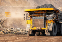 NSW IPC approves state’s largest ever coal mine expansion Large truck carrying load of thermal coal in dusty mine (industrial regions)
