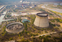 Forty years after Chernobyl, its legacy still resonates Aerial shot of Chernobyl nuclear reactors with straight canals around in spring