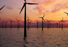 Victoria commits $125M to progress offshore wind terminal Offshore wind farm against beautiful orange sunset (bunbury)