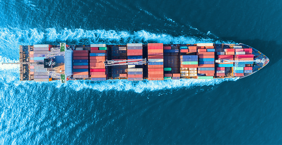 cargo-ship Aerial view of cargo ship loaded with containers at sea (shipping)