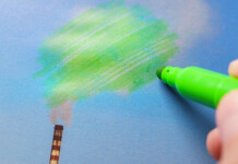 Gas industry calls for climate litigation ‘crack down’—but what about democracy? Hand uses green marker to colour in smoke pouring from chimney (environmental claims)