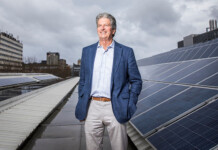 Father of modern solar looks to new tech frontier Scientia Professor Martin Green stands next to rooftop solar panels with buildings in the background (solar pioneer)