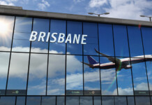 Sustainable aviation fuel takes off at Brisbane Airport Mirrored front of Brisbane Airport terminal with reflection of plane