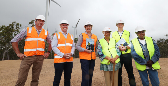 Government officials in front of wind turbines at Kaban Green Power Hub (SuperGrid)