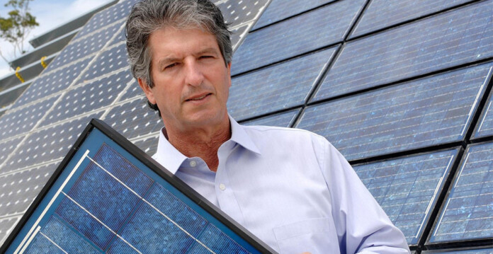 Professor Martin Green holding solar cells (solar prize)