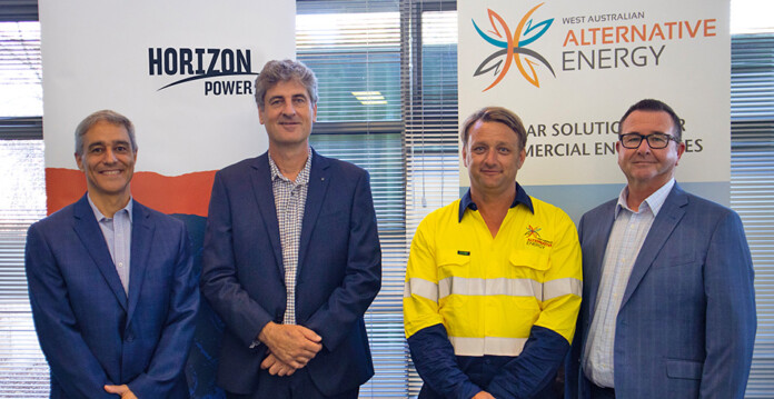 Officials from Horizon Power and WAAE stand in front of company logos and pose for photo
