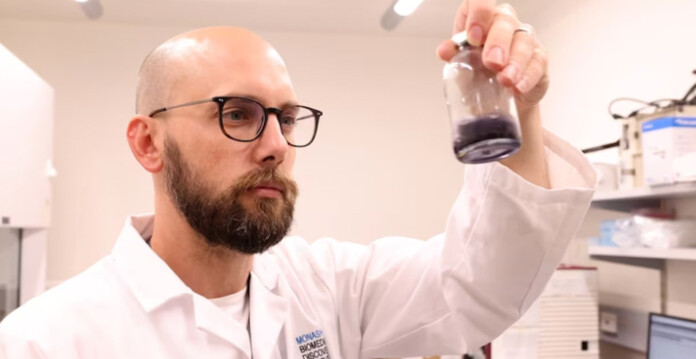Scientists holds liquid in a vial in laboratory (enzyme)