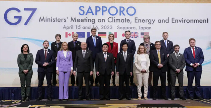 G7 leaders stand in front of summit livery for photo opportunity