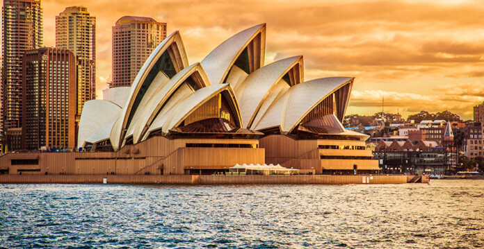 Sydney Opera House against golden sky at dawn