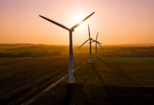 Goombi Wind Farm lodges Qld-first development application Image of wind turbines against beautiful peach coloured sunrise (moah creek)