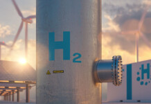 Despite spending billions on green hydrogen, Australia’s policies don’t seem to be working Hydrogen concept image with wind turbines and solar panels behind hydrogen pipe and big battery with H2 on it (headstart)