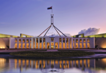 Historic environmental reforms to pass Australian Parliament External shot of Parliament House in Canberra with beautiful purple sky in the background (clean energy transformation)