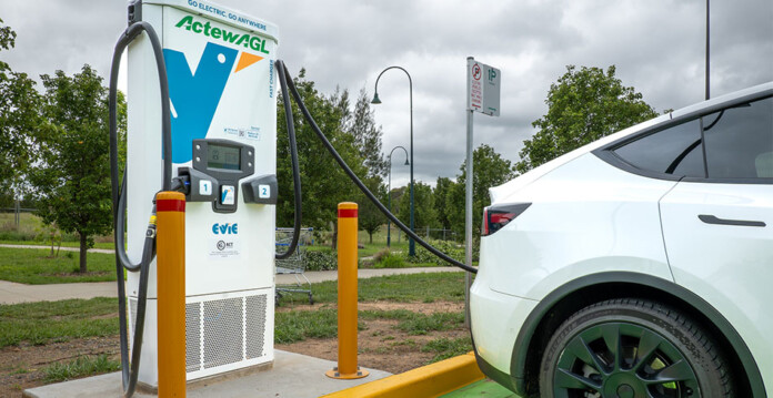 White electric vehicle charging at new Evie Networks and ActewAGL branded EV fast charger
