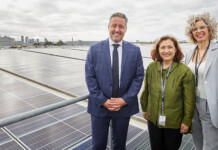 Australia’s longest serving energy minister to retire Three smiling people standing on Equinix's new solar rooftop system in Melbourne