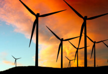 Asbestos-containing wind turbines spark safety response Wind turbines at sunset with orange clouds over blue sky (ark wooroora)