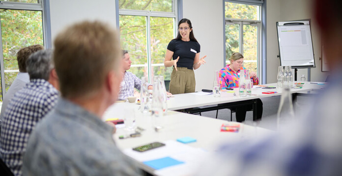 United Energy employee speaks to consultation group at conference table in brightly lit room (underground power)