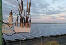 Goldman Sachs fund to acquire NOJA Power Close-up of NOJA's OSM Recloser with solar farm in background