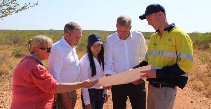 Group of people examine plans with Exmouth plains in background