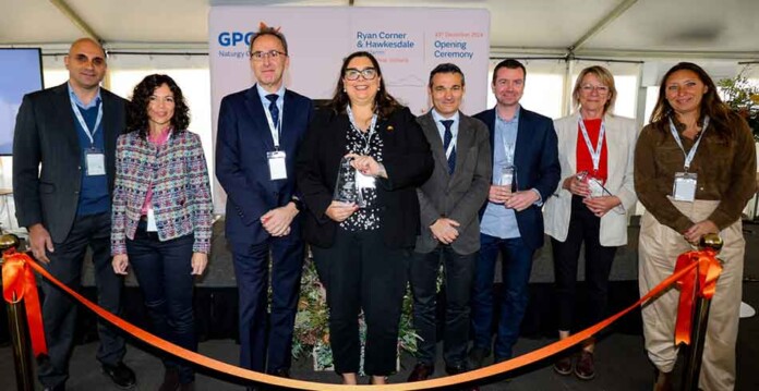 Male and female officials at wind farm ribbon cutting ceremony