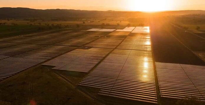 Solar farm at sunset with beautiful orange sky