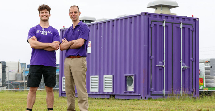 Two men in Endua shirts stand in front of purple hydrogen power bank