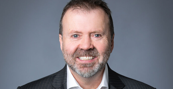Brendan-French Smiling head and shoulders shot of man wearing suit and tie