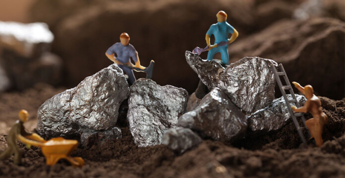 Concept image with small pieces of cobalt and tiny figurines appearing to mine them
