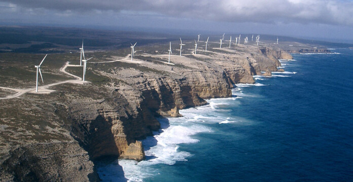 Aerial photograph of wind turbines along coastal cliff