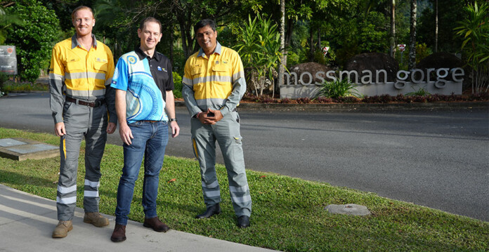 Three men stand at site of Mossman Gorge microgrid