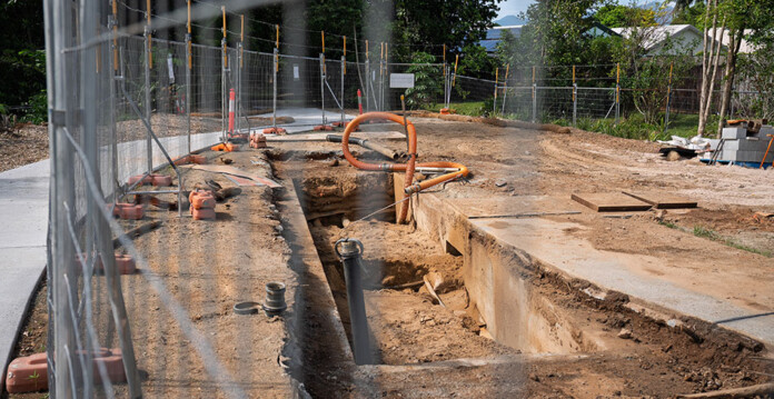 Mesh fence surrounding dirt and underground cable works