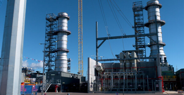 Gas turbine units at Kurri Kurri Power Station with bright blue sky overhead