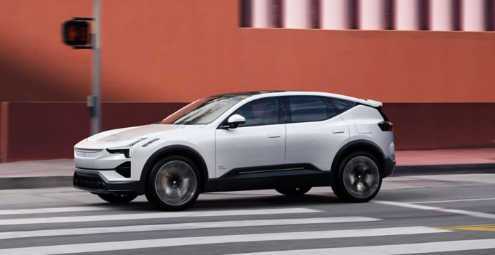 White Polestar 3 electric SUV driving on inner-city road