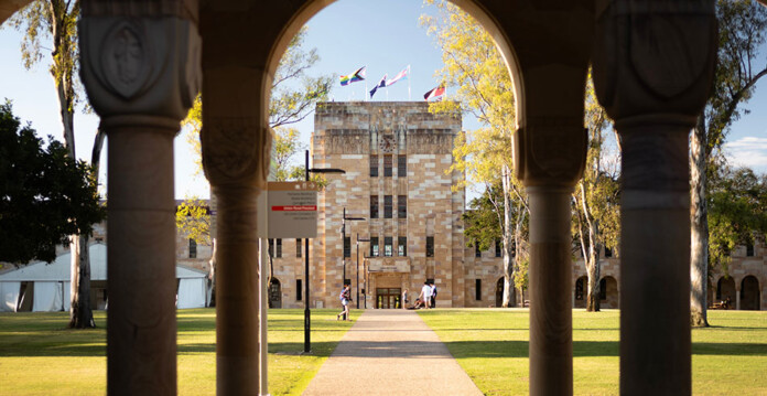 Large sandstone university building with arched columns
