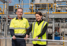 Carbon280 launches funding round after H2EX deal Man and woman wearing high-vis clothing cut ribbon in front of hydrogen pilot demonstration plant