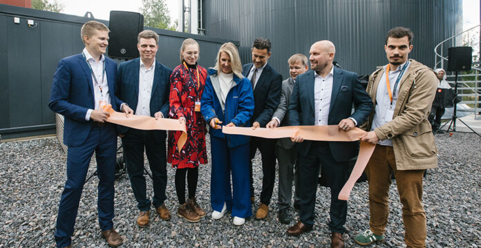 Officials cut a ribbon to inaugurate the sand battery built by Polar Night Energy