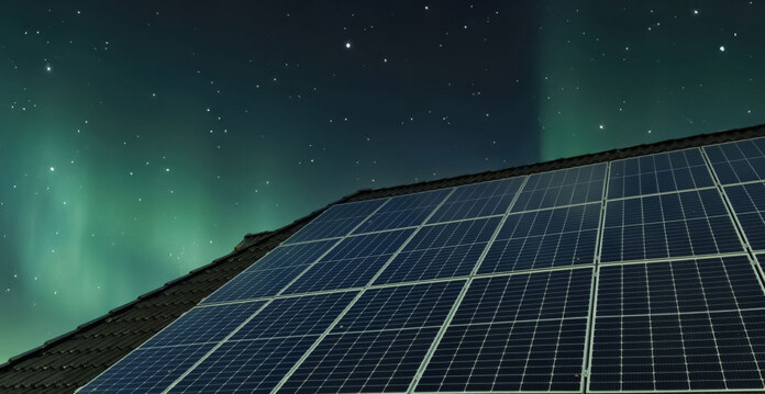 Roof with solar panels, with starry night sky and green aurora glowing over the top