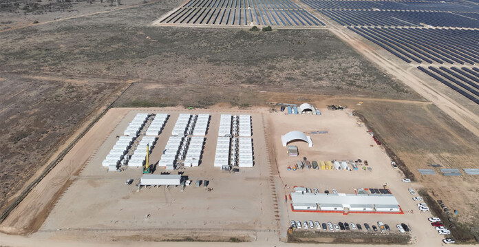 Aerial shots of long-duration battery project with solar farm in the background