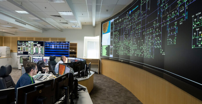 transgrid Staff sitting at computers in room with huge wall-to-wall screen