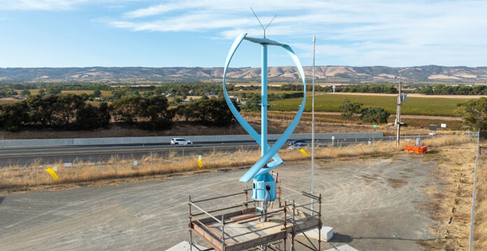 Aerial shot of blue vertical axis wind turbine prototype on raised platform
