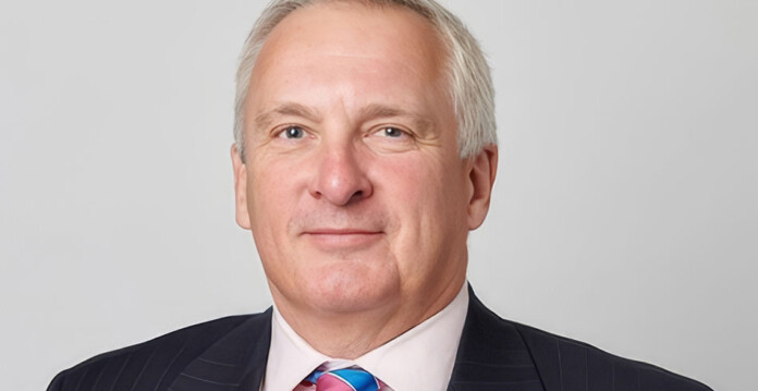 Head and shoulders shot of smiling male executive wearing a suit and tie