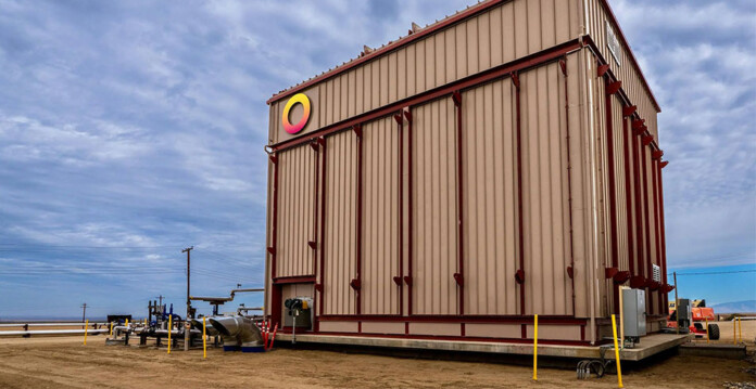Large battery at industrial site with blue cloudy sky overhead