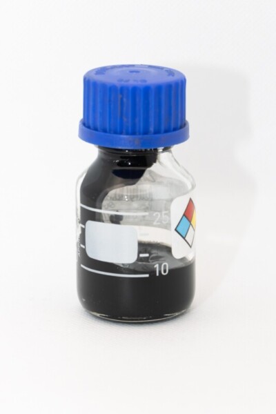 Black graphene paste in a small glass bottle with a blue lid