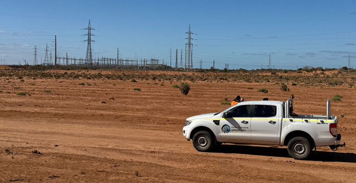White utility vehicle parked in front of site where Northern Battery project will be built