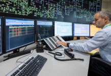 Control room upgrades to boost renewables access in NSW Transgrid employee sits at control room desk with computer monitors