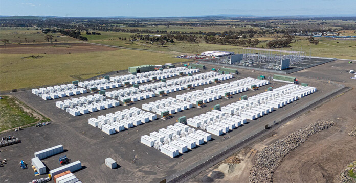 Battery units at renewable energy hub with blue sky overhead